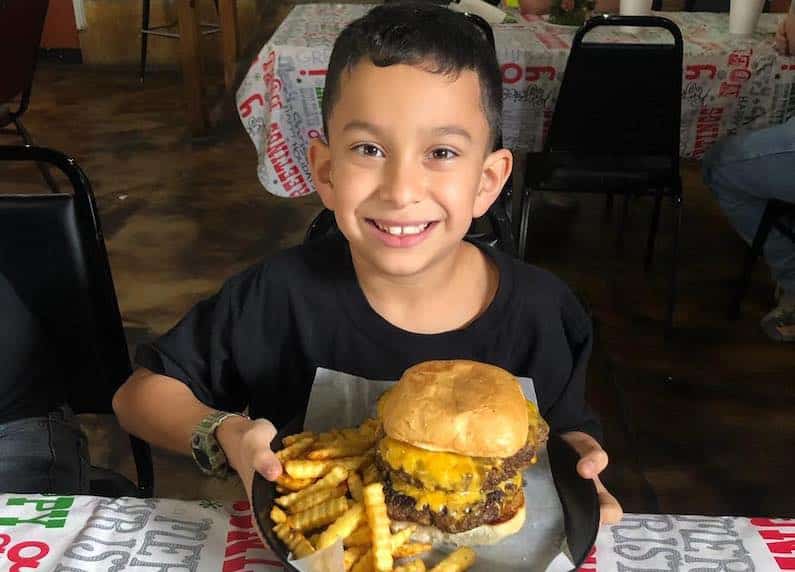 Things To Do This Weekend With Kids in San Antonio Child with Burger